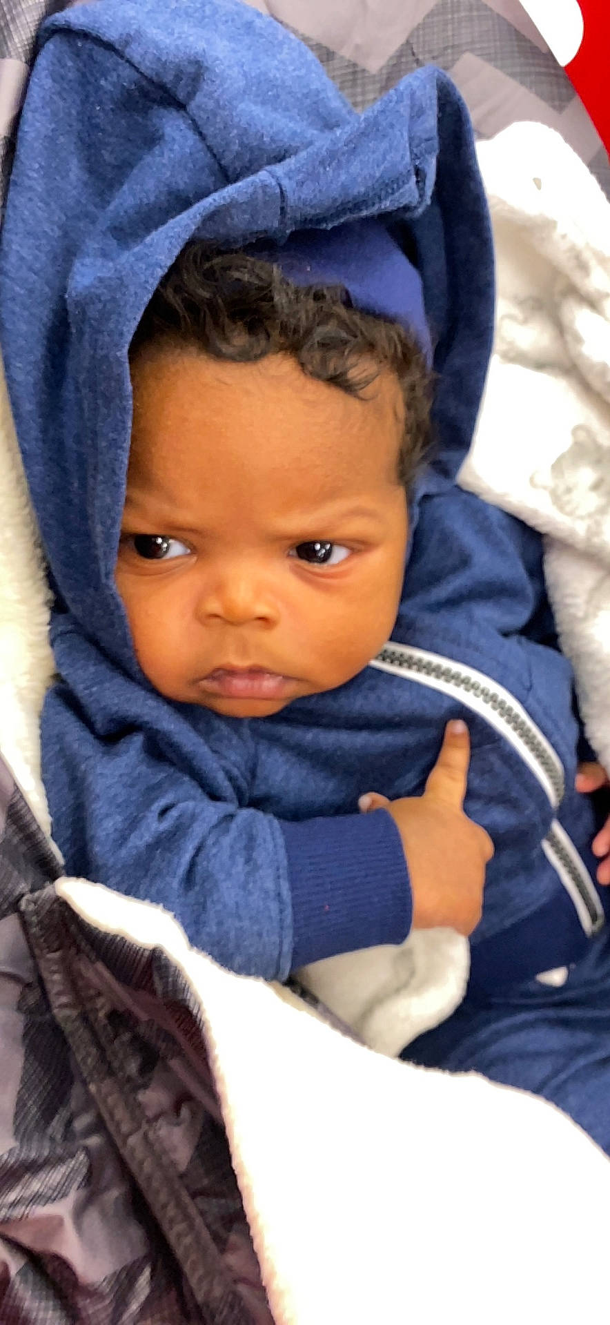 Jalen is registered to the contest to win money with this photo: azure, baby, baby_products, baby_toddler_clothing, blue, cheek, child, comfort, electric_blue, eye, fashion_accessory, fun, happy, iris, outerwear, person, product, skin, sleeve, toddler