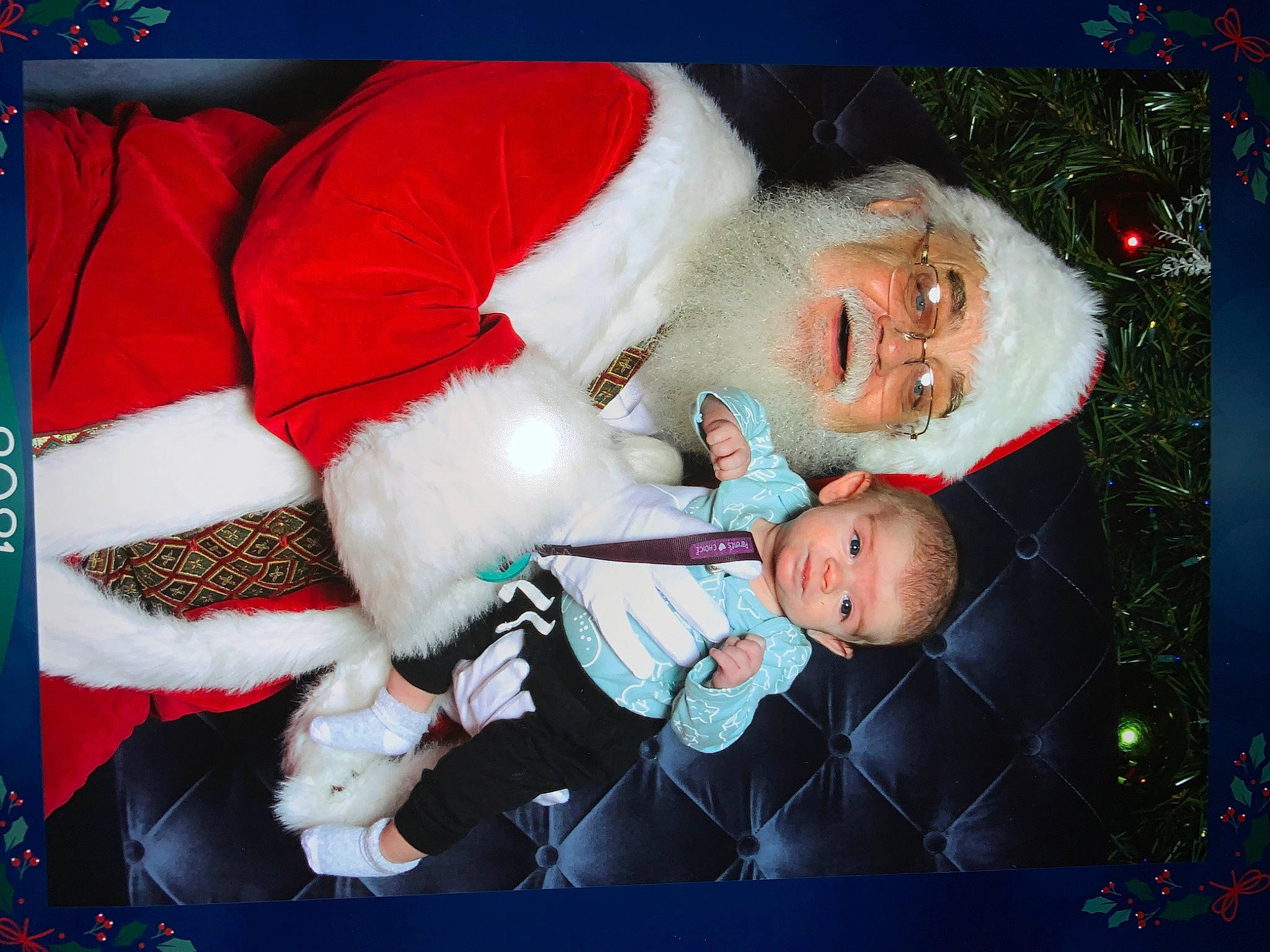 Aydan is registered to the contest to win money with this photo: baby, carmine, child, christmas_decoration, christmas_eve, christmas_ornament, christmas_tree, event, fictional_character, fun, happy, headwear, holiday, lap, person, red, santa_claus, smile, snapshot, textile