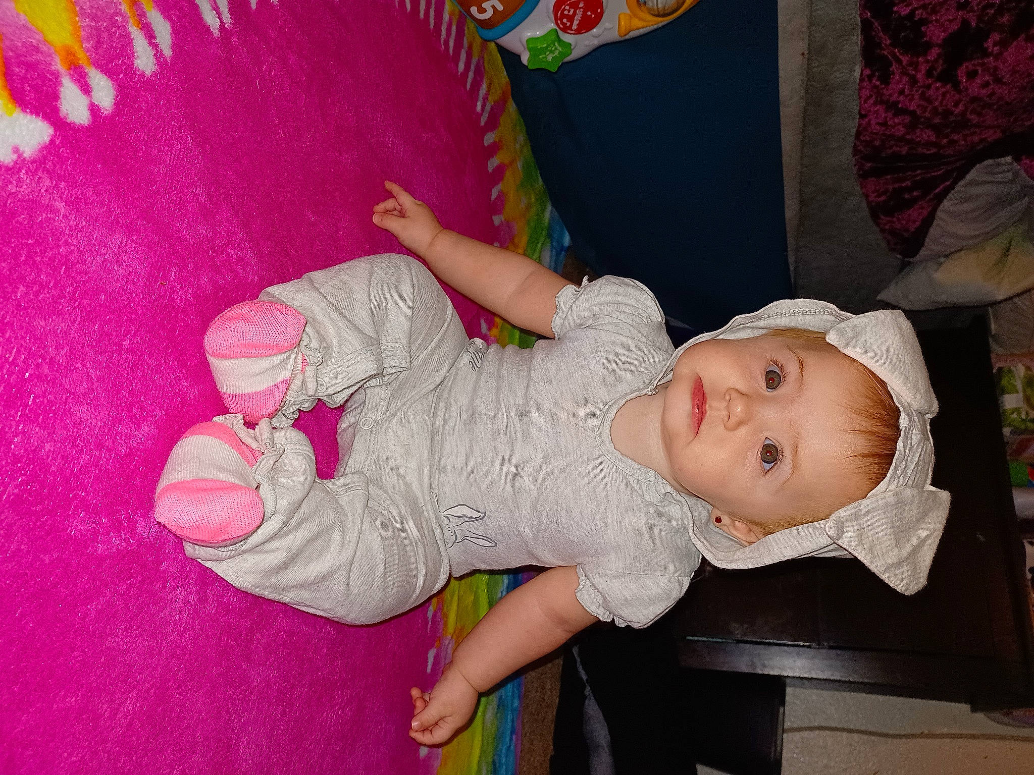 Skylar is registered to the contest to win money with this photo: arm, baby, baby_products, baby_toddler_clothing, cheek, child, clothing, fashion_accessory, finger, fun, hand, happy, hat, headgear, human_body, magenta, person, pink, room, skin