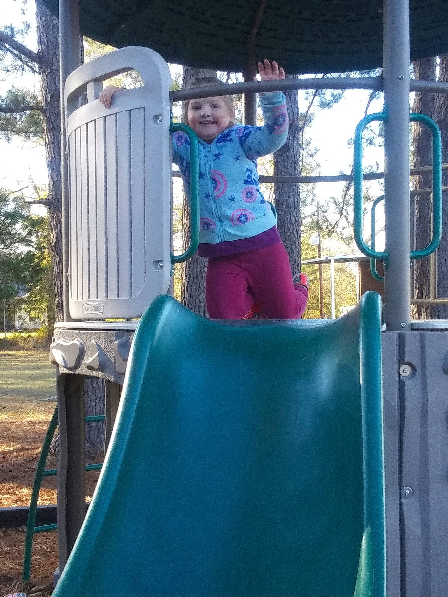 Serenity is registered to the contest to win money with this photo: child, chute, city, fun, headwear, human_settlement, joy, leisure, outdoor_play_equipment, person, play, playground, playground_slide, public_space, recreation, tree