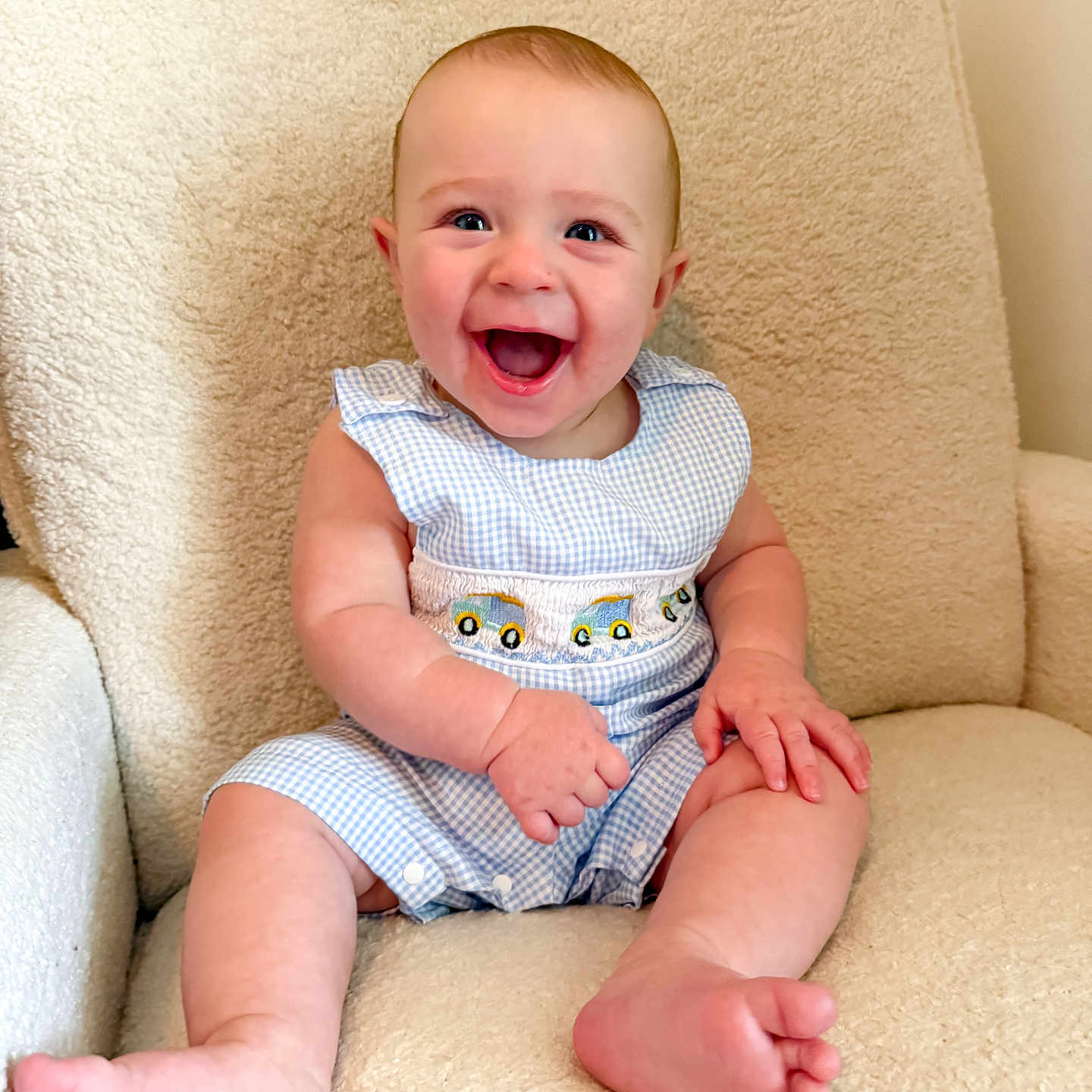 Hudson is registered to the contest to win money with this photo: baby, child, smiling, happy, sitting, armchair, plush, clothing, blue, white, cute, infant, portrait, indoors, skin, face, feet, hands, eyes, young