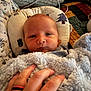 Stetson is registered to the contest to win money with this photo: baby, bed, blanket, blanket_texture, child, clothing, comfort, cozy, cushion, face, hand, indoor, infant, pattern, person, pillow, quilt, resting, soft, young