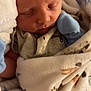 Stetson is registered to the contest to win money with this photo: baby, blanket, closeup, cozy, cute, face, human, indoors, infant, mittens, newborn, pacifier, peaceful, portrait, resting, sleeping, soft, tiny, warm, wrapped