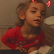 Ines participe au concours pour gagner de l'argent avec cette photo : child, red_shirt, butterfly, face, neon_horns, mischievous, indoor, cozy, expression, person, leaning, clothing, hair, table, fabric, background, floor, hand, portrait, casual