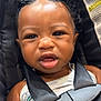 Josiah joined the competition — help win amazing prizes! baby, child, car_seat, straps, curly_hair, two_buns, face, expression, infant, safety, warning_label, clothing, tank_top, black_hair, seatbelt, close_up, indoor, person, cute, portrait