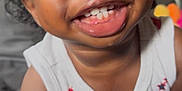 Josiah joined the competition — help win amazing prizes! toddler, child, smiling, curly_hair, white_top, teeth, happy, closeup, indoor, person, skin, face, arm, sitting, cute, young_child, infant, portrait, baby, expression