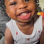 toddler, child, smiling, curly_hair, white_top, teeth, happy, closeup, indoor, person, skin, face, arm, sitting, cute, young_child, infant, portrait, baby, expression