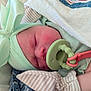 Line is registered to the contest to win money with this photo: newborn, baby, sleeping, pacifier, hat, bow, soft_fabric, blanket, infant, cute, closeup, peaceful, resting, skin, cheeks, clothing, baby_gloves, indoor, portrait, toddler
