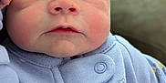 Line is registered to the contest to win money with this photo: baby, infant, face, closeup, onesie, lavender, bee_pattern, hand, curious, chubby_cheeks, skin, eyes, nose, mouth, fist, blurred_background, tattoo, holding, soft_texture, portrait