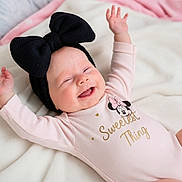 Line joined the competition — help win amazing prizes! baby, infant, smiling, headband, bow, pink_onesie, minnie_mouse, text_on_clothing, happy, lying_down, blanket, soft_texture, cute, child, portrait, baby_clothes, indoor, closeup, cheerful, adorable