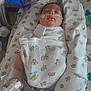 Alina Ebanks is registered to the contest to win money with this photo: newborn, baby, swaddled, hospital, medical_tubes, gloved_hand, crib, monitoring_equipment, blanket, lion_pattern, infant, bed, healthcare, patient, medical_care, nasal_cannula, wrapped, person, lying_down, pediatric