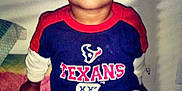 Cameron Goings joined the competition — help win amazing prizes! bed, blanket, casual, child, clothing, cute, happy, indoor, mickey_mouse, pants, person, portrait, shadow, shirt, sitting, smiling, texans, toddler, wall, young_child