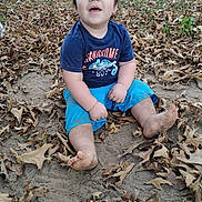 Aaron joined the competition — help win amazing prizes! child, toddler, baby, outdoor, autumn, fallen_leaves, nature, portrait, sitting, smiling, happy, face, person, blue_shirt, blue_shorts, barefoot, playful, grass, dirt, daylight