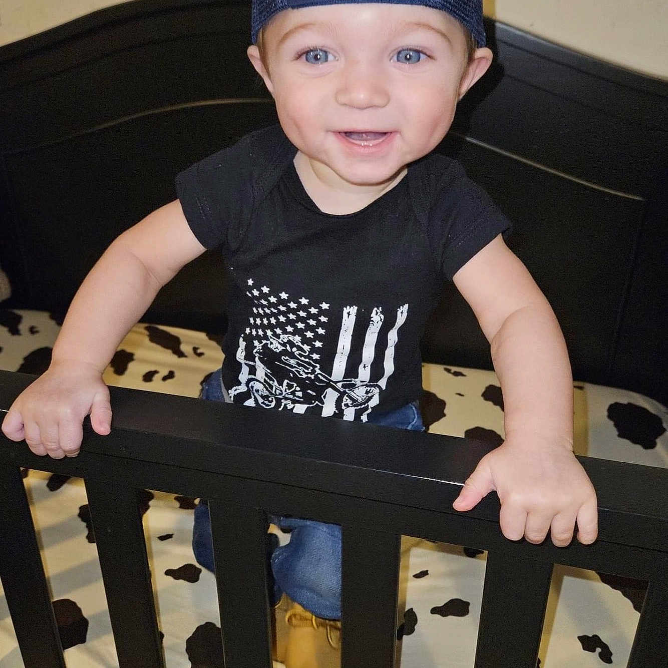 Joseph Jr is registered to the contest to win money with this photo: accessories, baby, bag, baseballcap, bed, cap, clothing, crib, face, furniture, handbag, hat, head, indoors, infantbed, pants, person, photography, portrait, t_shirt