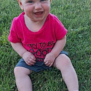 Lydia is registered to the contest to win money with this photo: baby, child, grass, outdoor, smiling, happy, sitting, pink_shirt, shorts, barefoot, sunlight, nature, playful, toddler, portrait, young_child, casual_clothing, summer, greenery, cute