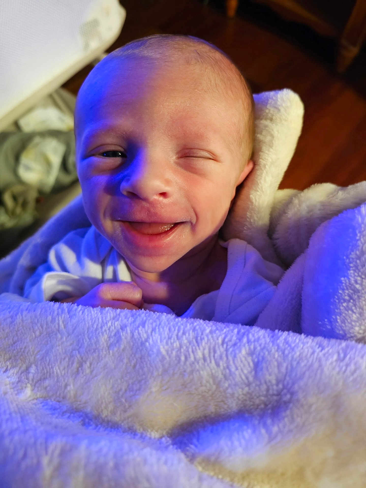Wyatt joined the competition — help win amazing prizes! baby, infant, blanket, smile, face, winking, newborn, cozy, soft, wrapped, cute, skin, hand, expression, portrait, warm, indoor, closeup, happy, child