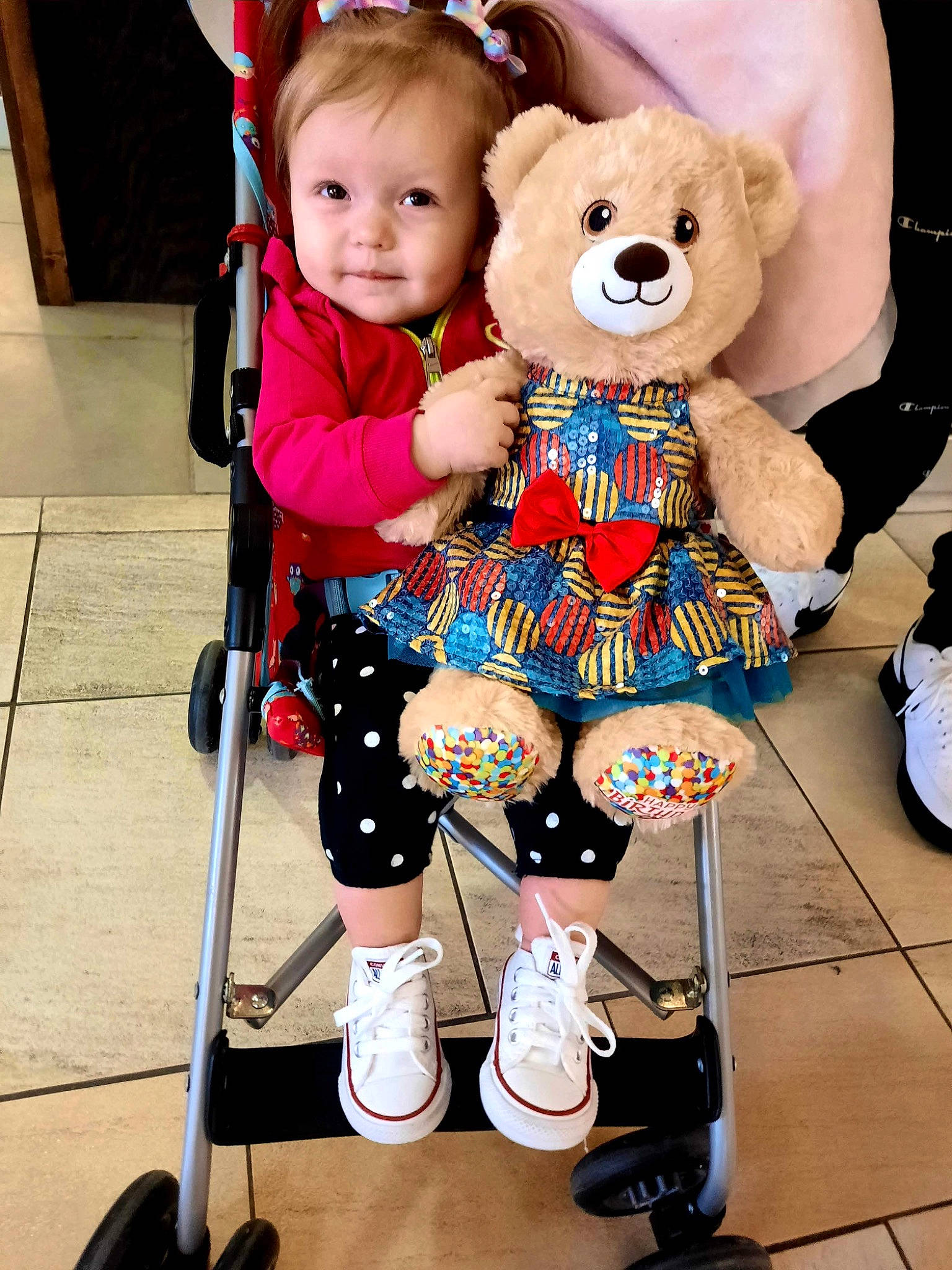 Letty is registered to the contest to win money with this photo: baby, baby_toddler_clothing, child, event, fashion_accessory, fun, happy, human_leg, knee, person, pink, product, red, shorts, skin, smile, snapshot, stuffed_toy, toddler, toy