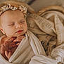 Charlie participe au concours pour gagner de l'argent avec cette photo : newborn, baby, sleeping, flower_crown, blanket, basket, soft, cozy, peaceful, portrait, infant, wrapped, hands, fingers, neutral_colors, closeup, head, face, resting, cute