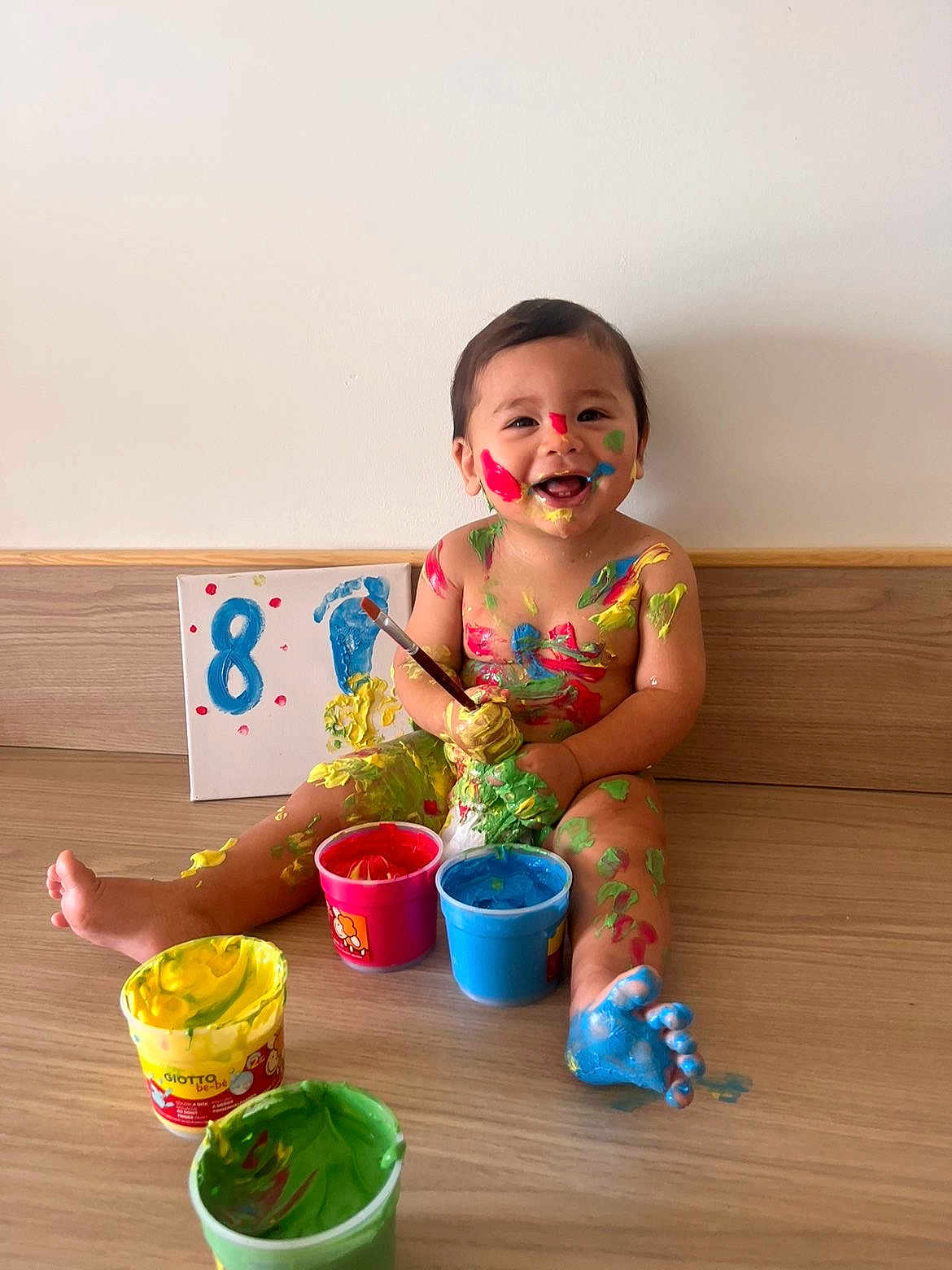 Noham participe au concours pour gagner de l'argent avec cette photo : baby, paint, colorful, messy, smiling, happy, child, floor, paintbrush, art, canvas, red_paint, blue_paint, yellow_paint, green_paint, barefoot, indoor, wooden_floor, playful, creative