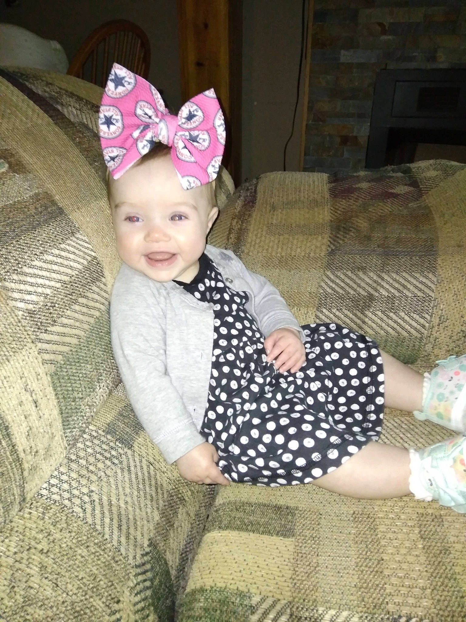 Elizabeth Grace is registered to the contest to win money with this photo: baby_products, baby_toddler_clothing, cap, child, costume_hat, couch, fashion_accessory, fun, happy, headband, headgear, headpiece, headwear, party_hat, pattern, person, room, sleeve, smile, sock