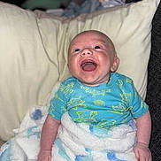 Ronniejay joined the competition — help win amazing prizes! baby, blanket, blue_onesie, child, clothing, comfort, cozy, cute, expression, face, happy, indoor, infant, lying_down, person, pillow, plush, skin, smiling, young