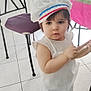Danny a rejoint le concours — aidez-le/la à gagner de superbes lots ! apron, chair, chef_hat, child, cute, furniture, home, indoor, kitchen, person, playing, serious_expression, standing, table, tablecloth, tile_floor, toddler, white_dress, wooden_utensils, young_child