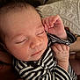 August is registered to the contest to win money with this photo: baby, sleeping, infant, striped_clothing, close_up, face, hand, newborn, peaceful, soft_light, portrait, cute, resting, tiny_fingers, cozy, human, skin, expression, indoors, comfort