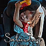child, toddler, car_seat, curly_hair, sippy_cup, blanket, car_interior, happy, smiling, seatbelt, window, daytime, clothing, person, vehicle, parking_lot, photography, text_overlay, playful, indoors