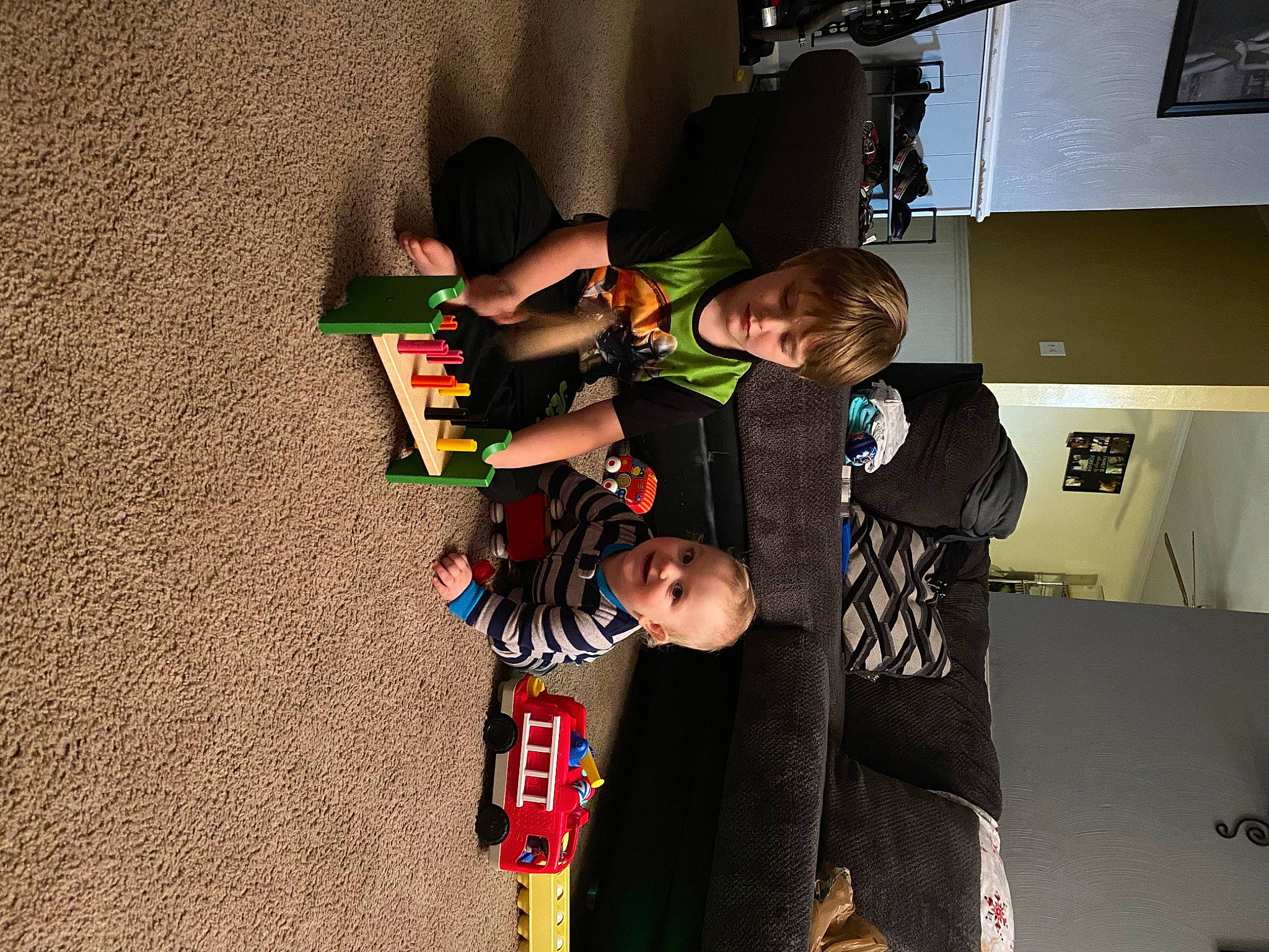 Mason is registered to the contest to win money with this photo: child, event, fictional_character, flooring, fun, holiday, joy, musical_instrument, person, play, recreation, room, shelf, t_shirt, toddler