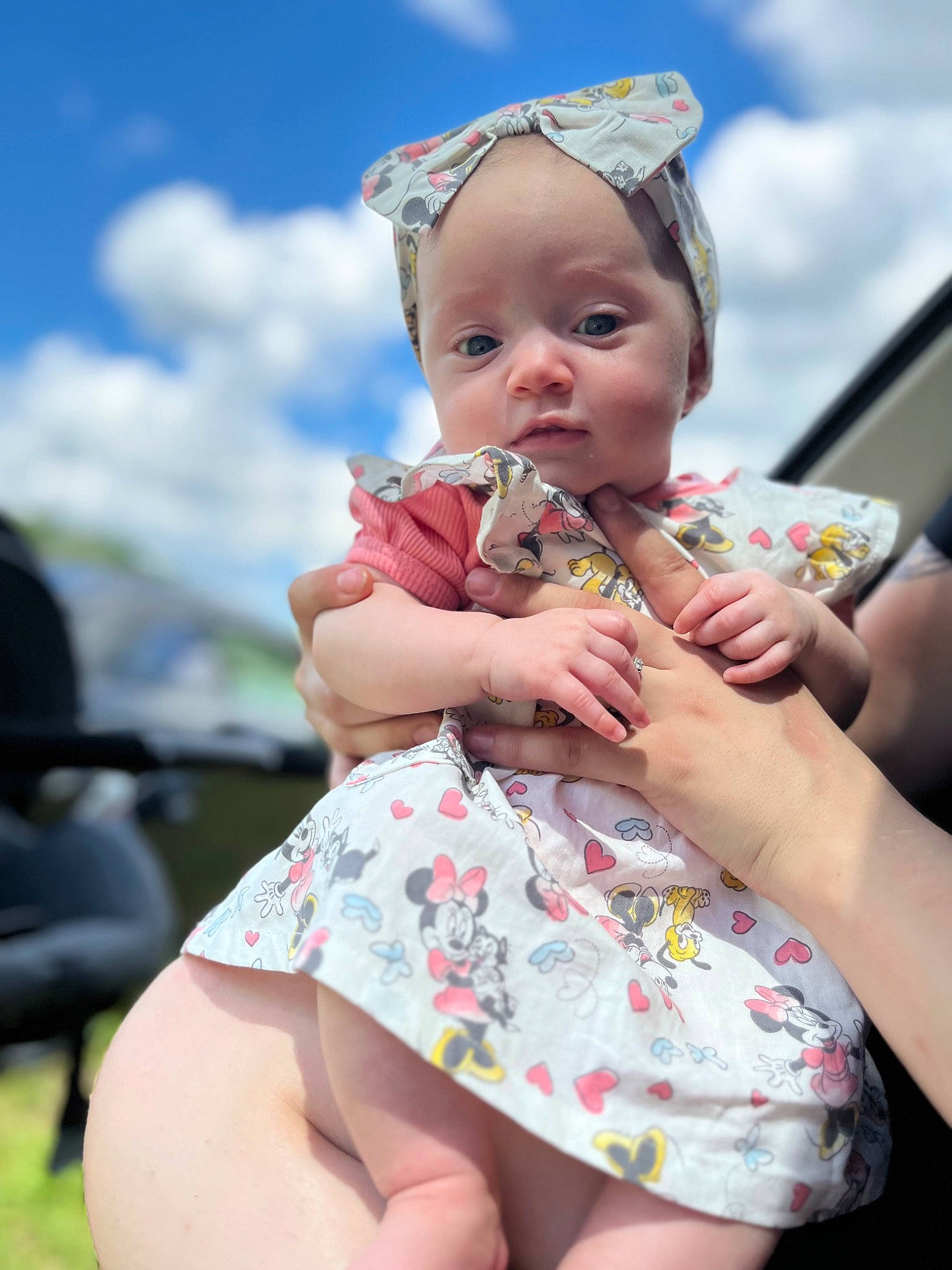 Elaina is registered to the contest to win money with this photo: baby, baby_toddler_clothing, child, cloud, dress, event, finger, fun, gesture, grass, hand, happy, hat, human_leg, jewellery, person, pink, sitting, skin, sky