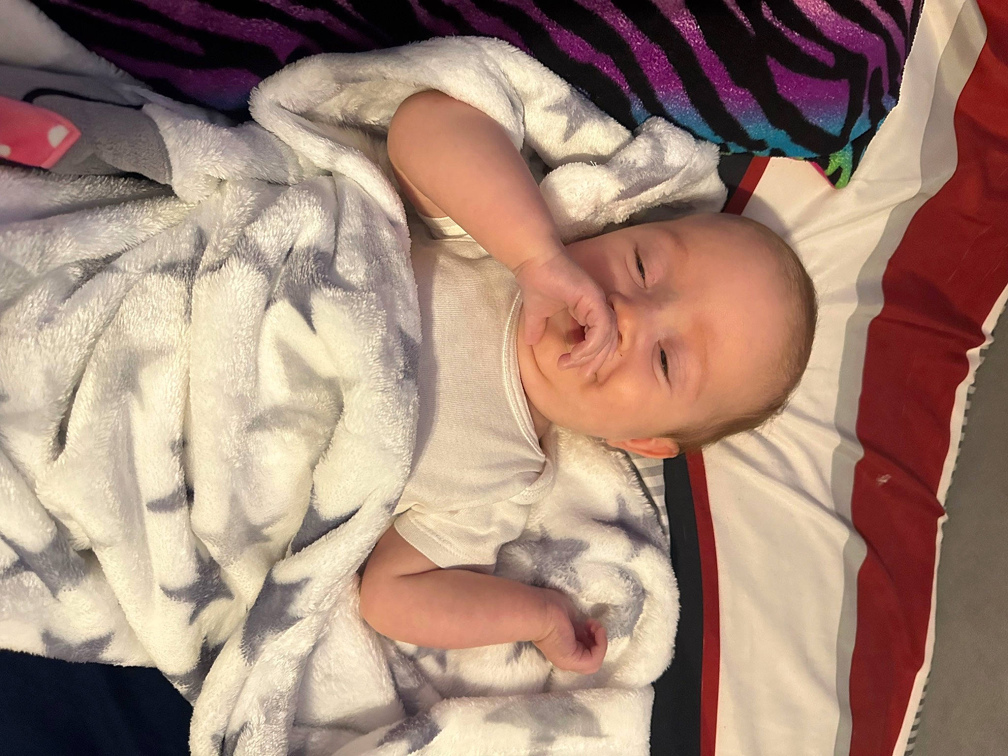 Elaina is registered to the contest to win money with this photo: arm, baby, baby_products, baby_sleeping, baby_toddler_clothing, cheek, child, comfort, finger, gesture, hand, happy, human_body, linens, nail, pattern, person, room, skin, thumb