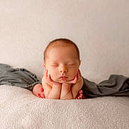 Ryker joined the competition — help win amazing prizes! baby, blanket, cheeks, closeup, cozy, hands_under_chin, head, infant, neutral_background, newborn, peaceful, portrait, resting, skin, sleeping, small_feet, soft_texture, studio_shot, toes, wrapped