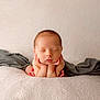 baby, blanket, cheeks, closeup, cozy, hands_under_chin, head, infant, neutral_background, newborn, peaceful, portrait, resting, skin, sleeping, small_feet, soft_texture, studio_shot, toes, wrapped