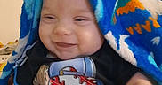 Ryker joined the competition — help win amazing prizes! baby, baseball, blanket, blue, child, clothing, cozy, cute, dreamcatcher, face, furniture, happy, indoor, pattern, person, portrait, shirt, smiling, soft_lighting, toddler