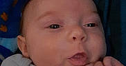 Ryker joined the competition — help win amazing prizes! adult_partial_face, baby, bedding, blanket, blue_blanket, child, close_up, clothing, cozy, eyes, face, fingers, hands, holding, indoor, infant, mouth, portrait, skin, tongue