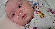 Ryker joined the competition — help win amazing prizes! baby, bed, blanket, care, child, closeup, cute, face, healthcare, hospital, indoors, infant, lying_down, medical, oxygen_tube, pajamas, patient, person, sleepy, tired