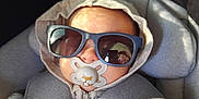 Ryker is registered to the contest to win money with this photo: baby, child, pacifier, sunglasses, hoodie, blanket, car_seat, infant, hand, face, cozy, cute, child_in_car_seat, accessory, indoor, portrait, baby_clothing, infant_baby, seatbelt, adorable
