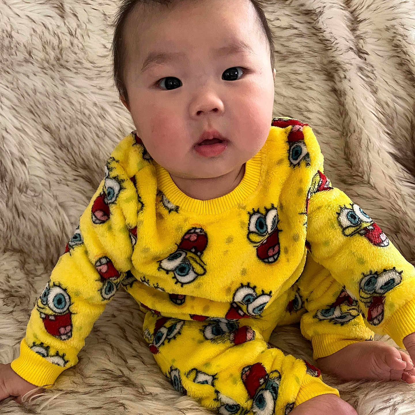 Hudson is registered to the contest to win money with this photo: animal, baby, bird, bodypart, clothing, couch, crawling, face, finger, furniture, happy, head, newborn, pajamas, person, photography, portrait, sitting, sleeve, smile