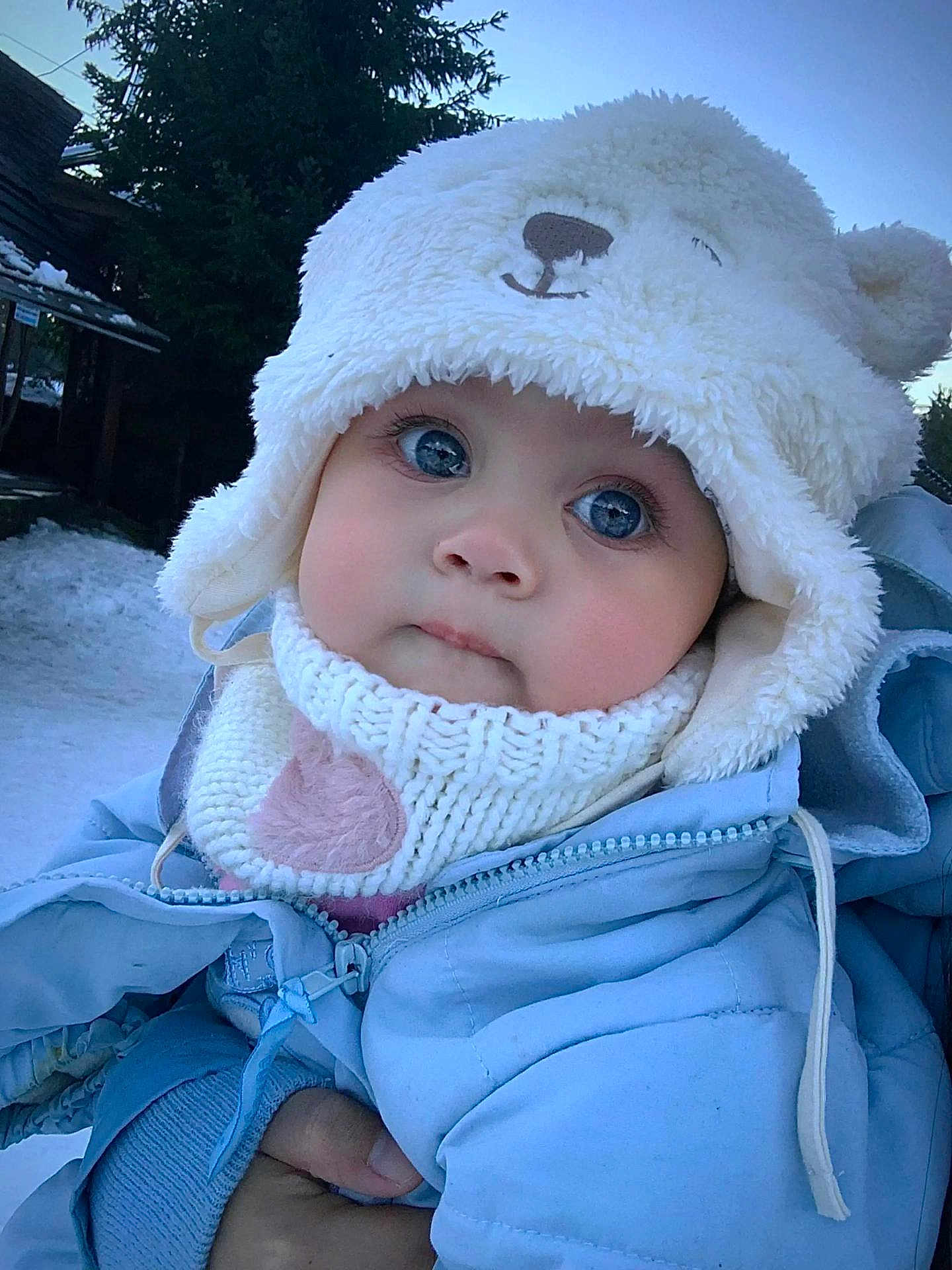 Cassie joined the competition — help win amazing prizes! baby, child, winter_clothing, hat, knitted_scarf, blue_jacket, outdoor, snow, cold_weather, cute, face, big_eyes, person, holding_hand, forest, tree, winter, warm_clothes, close_up, infant