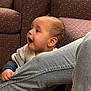 toddler, child, jeans, hand, couch, upholstery, pattern, furniture, indoor, person, clothing, sitting, expression, face, skin, arm, happy, curious, baby, young