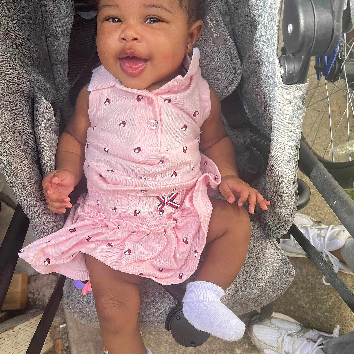 Noor joined the competition — help win amazing prizes! alloywheel, baby, clothing, dress, face, footwear, happy, head, hosiery, pants, person, photography, portrait, shoe, shorts, sitting, skirt, sneaker, sock, stroller