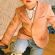 Timothe participe au concours pour gagner de l'argent avec cette photo : blazer, blue_eyes, casual, chain_necklace, child, confidence, cute, fashion, indoor, jeans, patterned_wall, person, playful, portrait, sneakers, toddler, top_knot, toy_car, wooden_floor, young