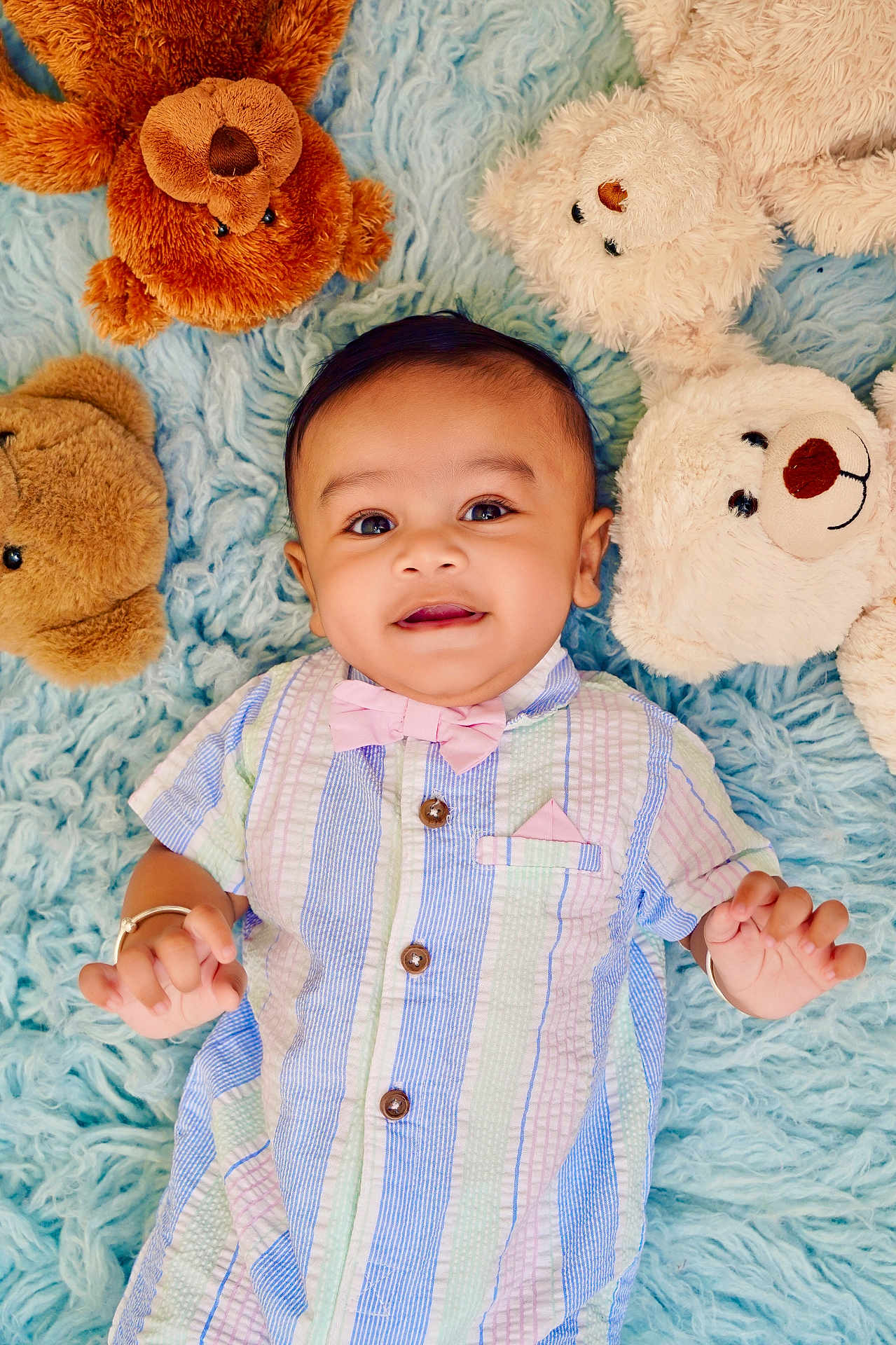 Yunay joined the competition — help win amazing prizes! baby, child, teddy_bear, plush_toy, blue_rug, smiling, cute, pastel_colors, bow_tie, striped_shirt, happy, infant, soft_texture, lying_down, indoor, portrait, playtime, cozy, adorable, person