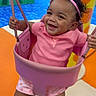 toddler, child, swing, playground, pink_crown, pink_clothing, smiling, happy, indoor_play_area, colorful, play_equipment, legs, headband, baby, fun, joy, person, cute, active, motion