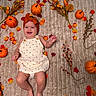 baby, infant, child, smiling, autumn, fall, pumpkin, pumpkins, leaves, flowers, berries, headband, bow, orange, romper, laying_down, blanket, portrait, seasonal, photography
