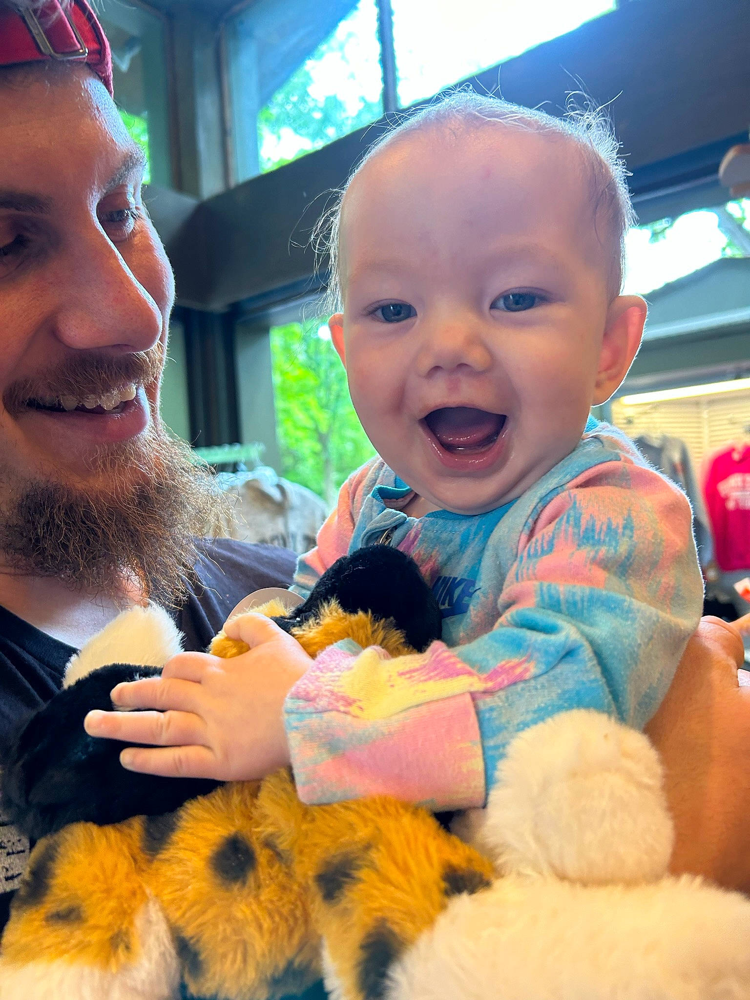 Kimberley is registered to the contest to win money with this photo: baby, baby_toddler_clothing, beard, child, event, facial_expression, finger, fun, gesture, glove, happy, mouth, organ, person, plant, skin, smile, thumb, toddler, toy