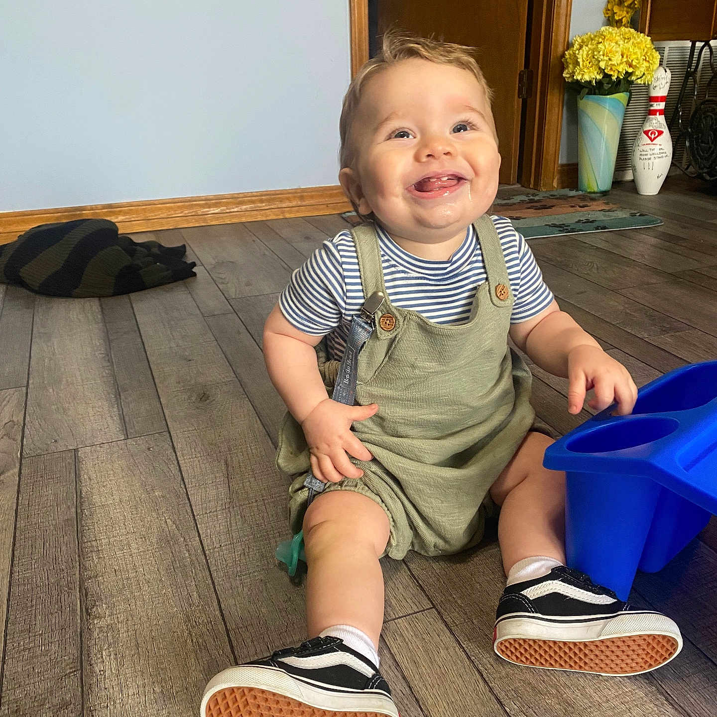 Atlas is registered to the contest to win money with this photo: baby, clothing, face, footwear, hardwood, head, jar, pants, person, photography, plant, planter, portrait, pottedplant, pottery, shoe, shorts, sitting, vase, wood