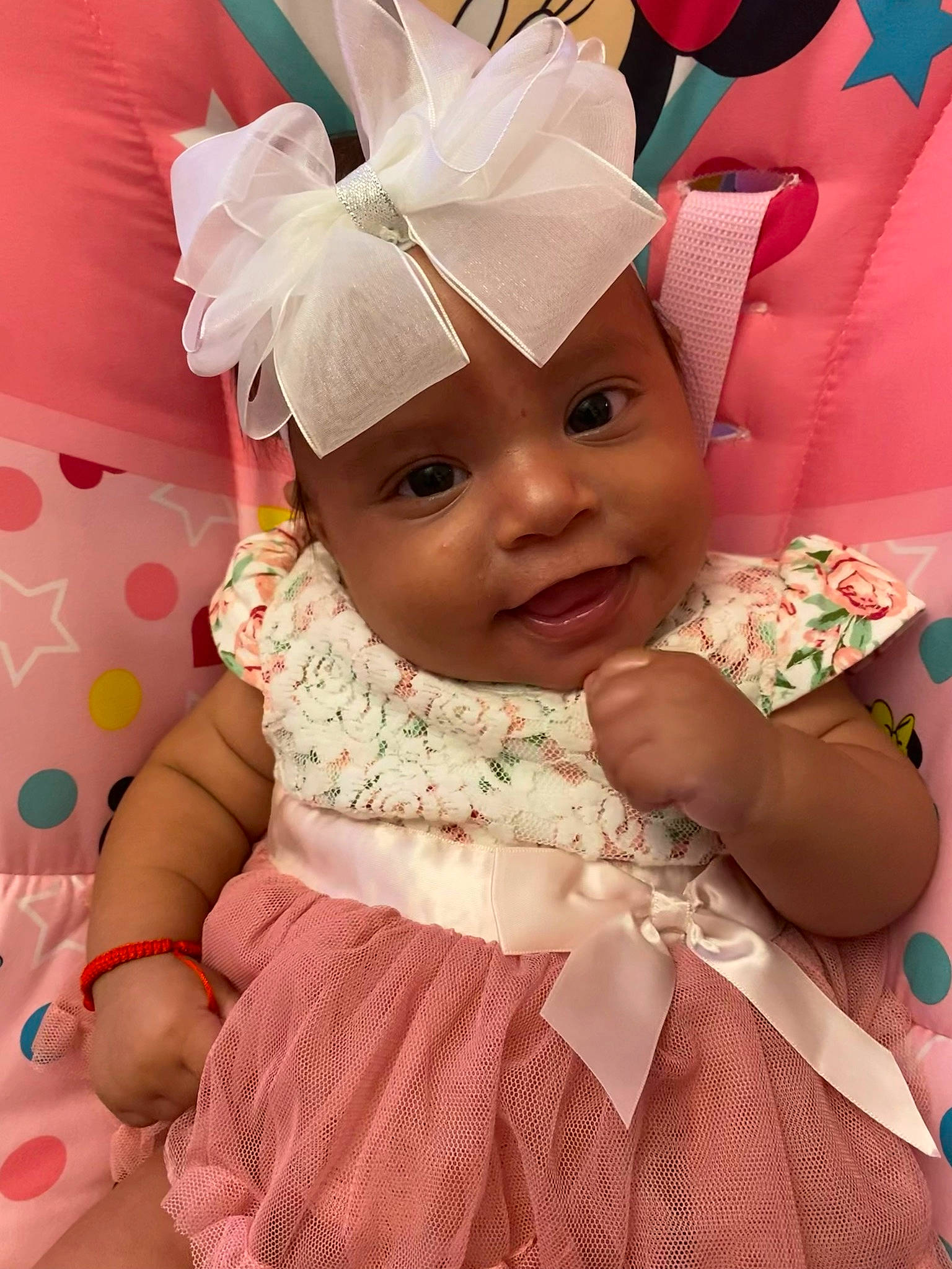 Katalina is registered to the contest to win money with this photo: baby, baby_toddler_clothing, child, costume_hat, dress, face, happy, headband, headgear, headpiece, headwear, helmet, magenta, person, petal, pink, skin, sleeve, smile, textile