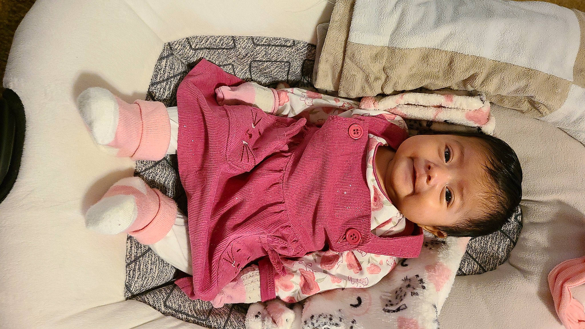 Lisanna is registered to the contest to win money with this photo: arm, baby, baby_toddler_clothing, clothing, comfort, dress, hand, happy, headgear, human_body, linens, lip, outerwear, person, pink, product, skin, sleeve, smile, textile