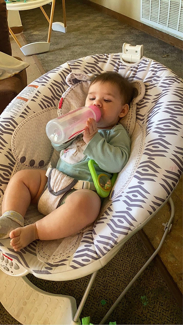 Lyla is registered to the contest to win money with this photo: baby, baby_products, baby_safety, baby_toddler_clothing, chair, child, circle, comfort, flooring, foot, grass, human_leg, leisure, person, play, shipping_box, sitting, thigh, thumb, toddler